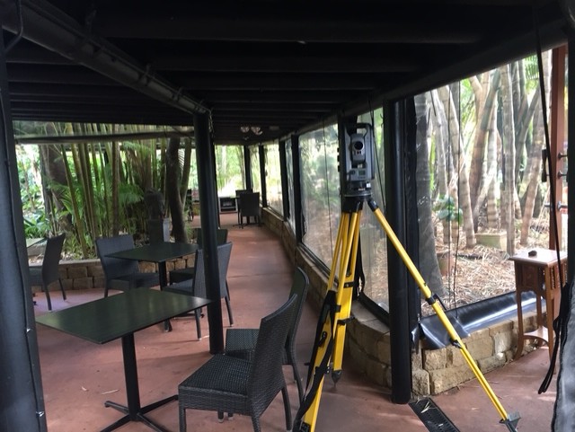 Trimble total station set up under a covered veranda